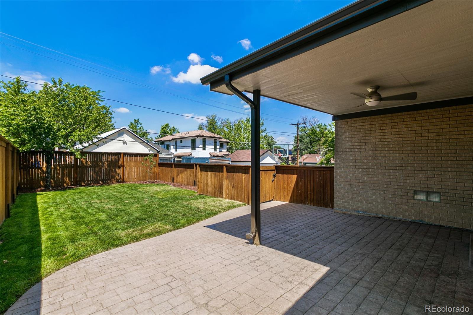 1643 South Ogden Street Denver, CO 80210 - Photo 34 of 39 a patio with table and chairs with wooden floor and fence