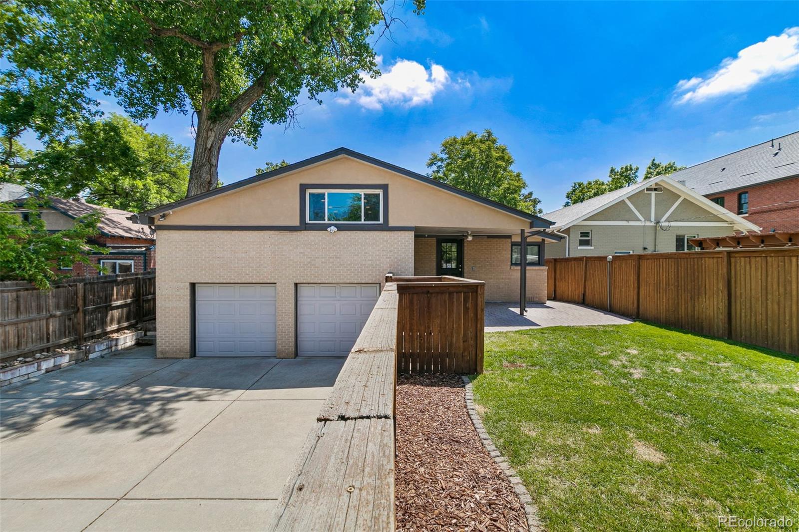 1643 South Ogden Street Denver, CO 80210 - Photo 36 of 39 a front view of a house with a yard and garage