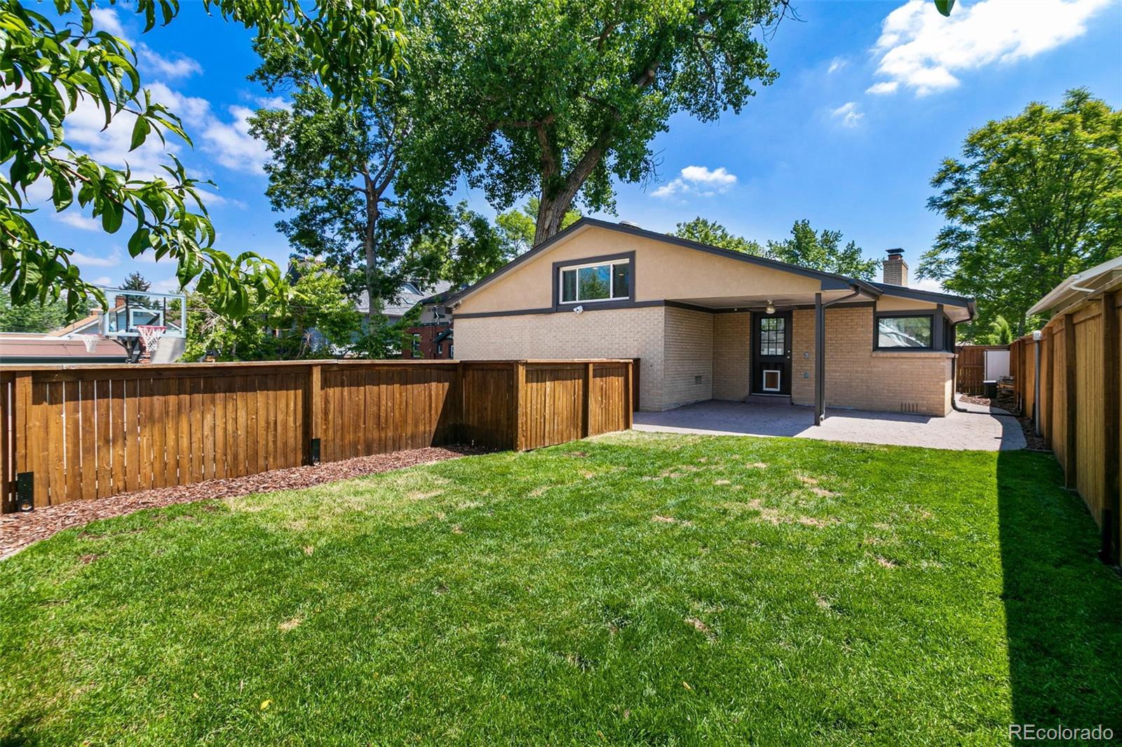 1643 South Ogden Street Denver, CO 80210 - Photo 37 of 39 a front view of a house with yard and green space
