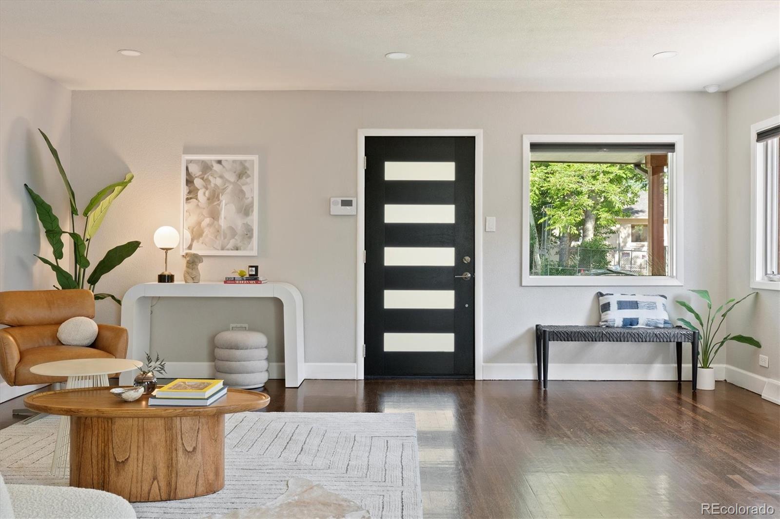 1643 South Ogden Street Denver, CO 80210 - Photo 4 of 39 a living room with furniture and a potted plant