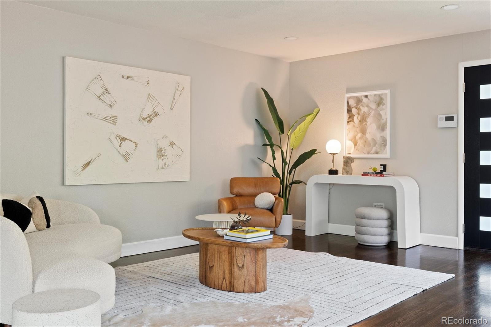 1643 South Ogden Street Denver, CO 80210 - Photo 7 of 39 a living room with furniture and a potted plant