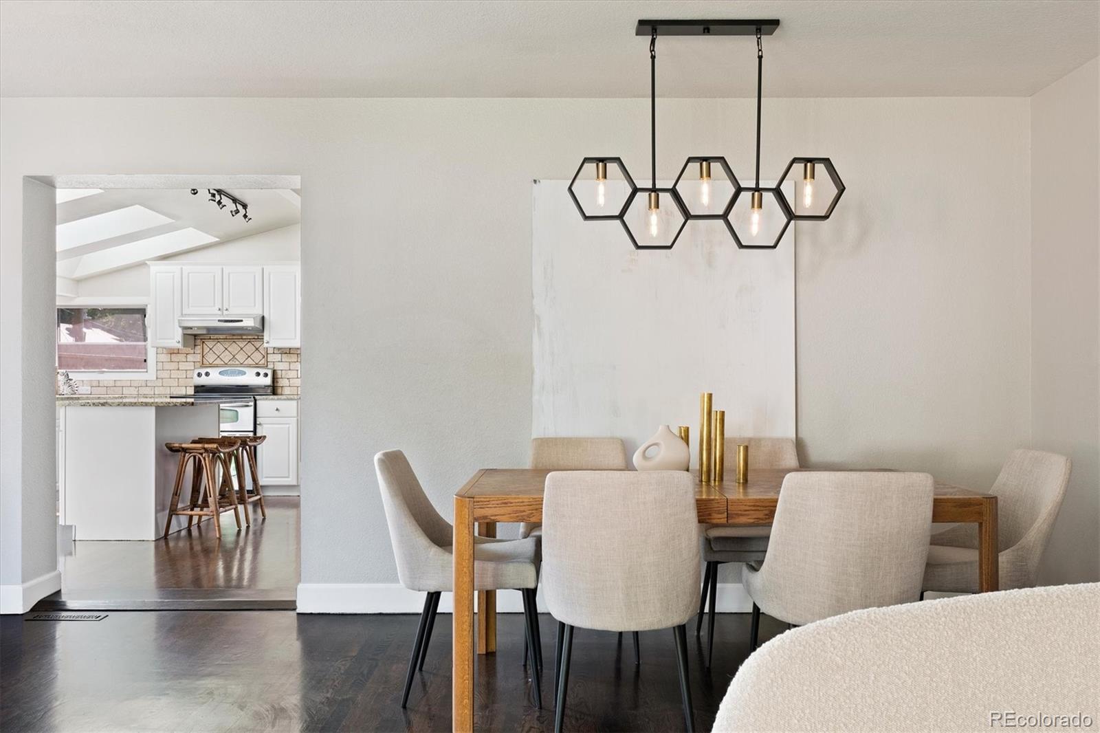 1643 South Ogden Street Denver, CO 80210 - Photo 9 of 39 a view of a dining room with furniture wooden floor and a chandelier