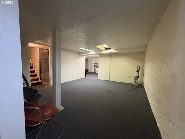 an empty room with closet and wooden floor