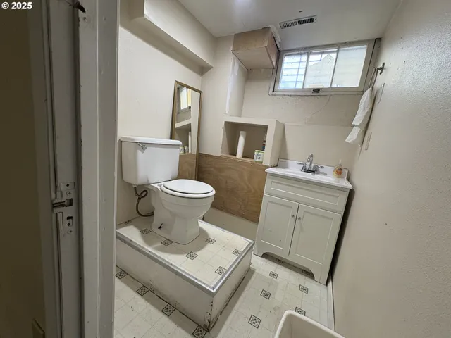 a bathroom with a toilet a sink and a mirror