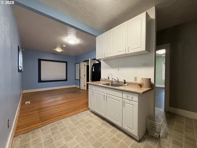 a kitchen with granite countertop a sink and cabinets