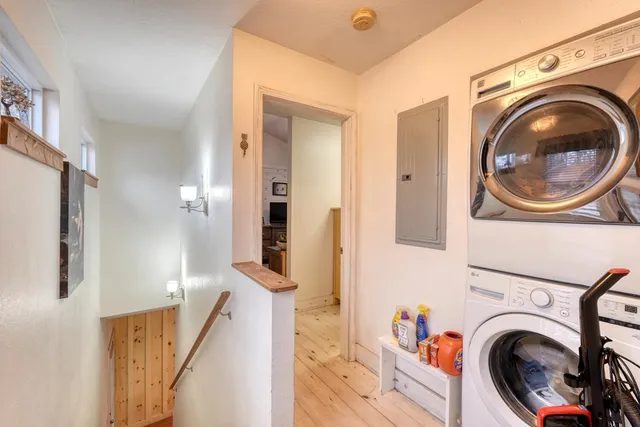 a view of a hallway with washer and dryer