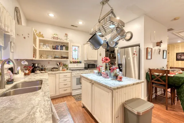 a kitchen with a sink stove and cabinets