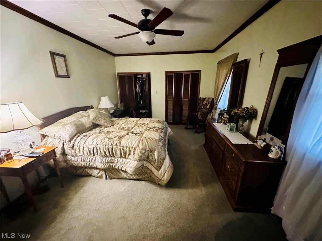 351 Rockdale Road Follansbee, WV 26037 - Photo 16 of 18 Carpeted bedroom featuring multiple closets, crown molding, and ceiling fan