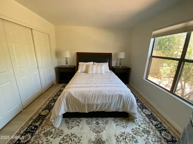 a bedroom with a bed and a window