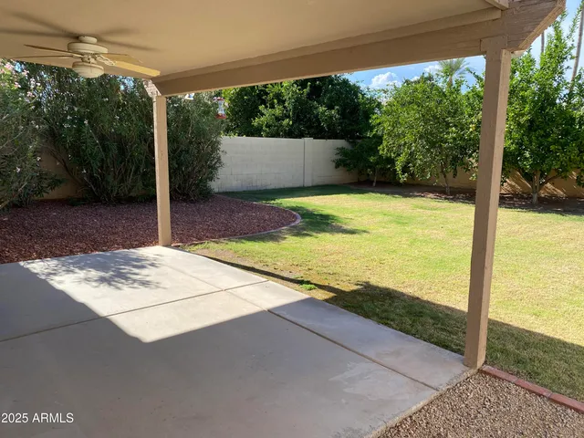 a view of a swimming pool with chairs and a table and chairs