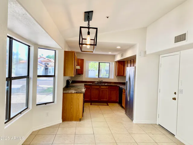 a kitchen with stainless steel appliances granite countertop a refrigerator and a stove