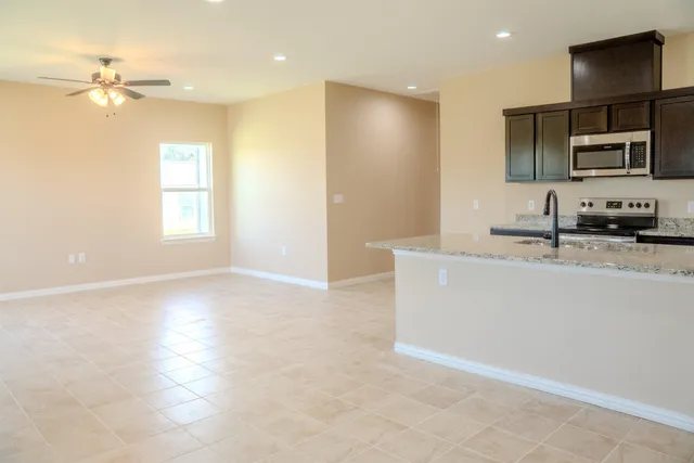 a view of a kitchen with microwave and cabinets