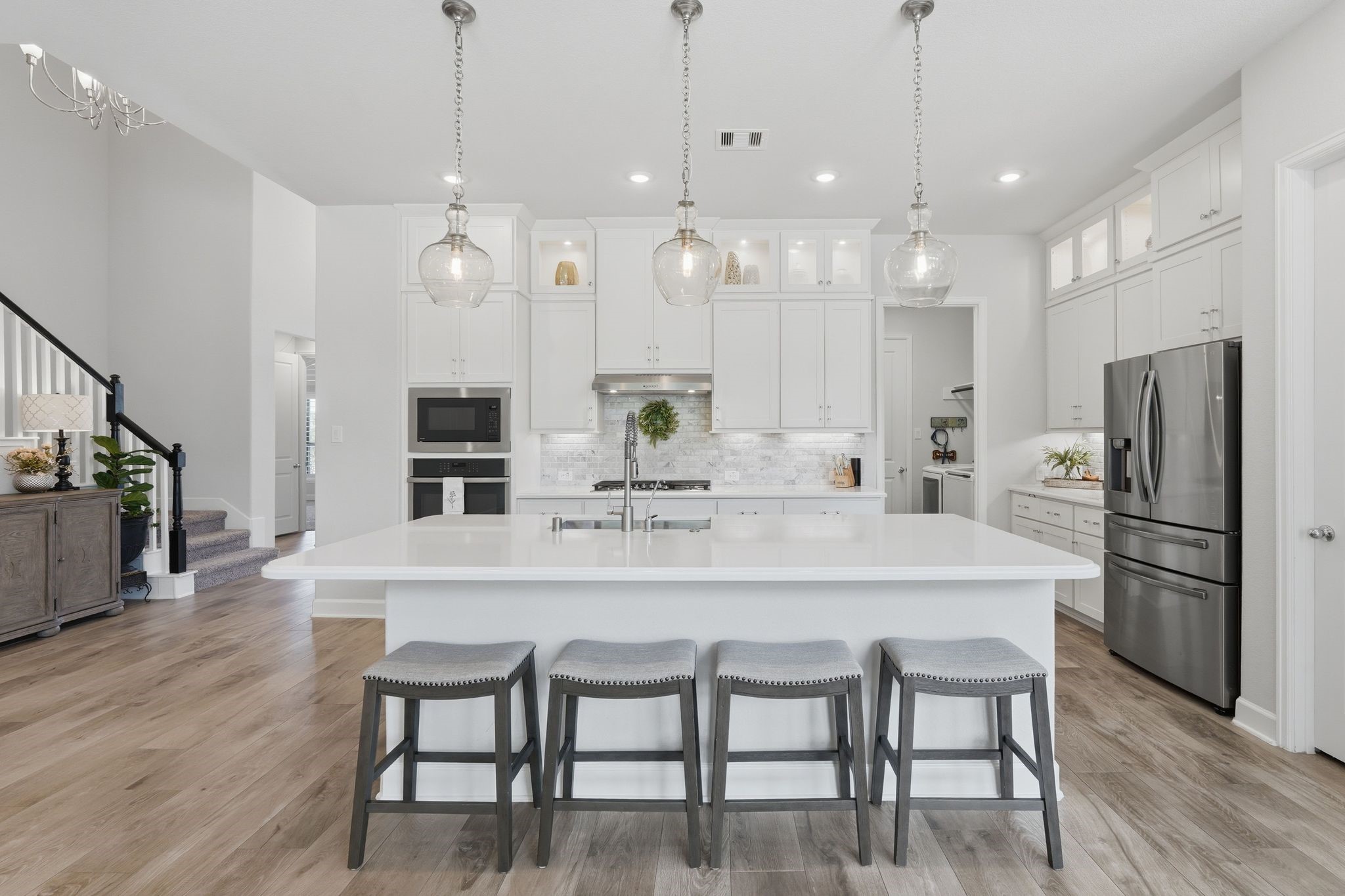25011 Oxbow Lake Lane Spring, TX 77389 - Photo 11 of 33 a kitchen with kitchen island white cabinets and stainless steel appliances
