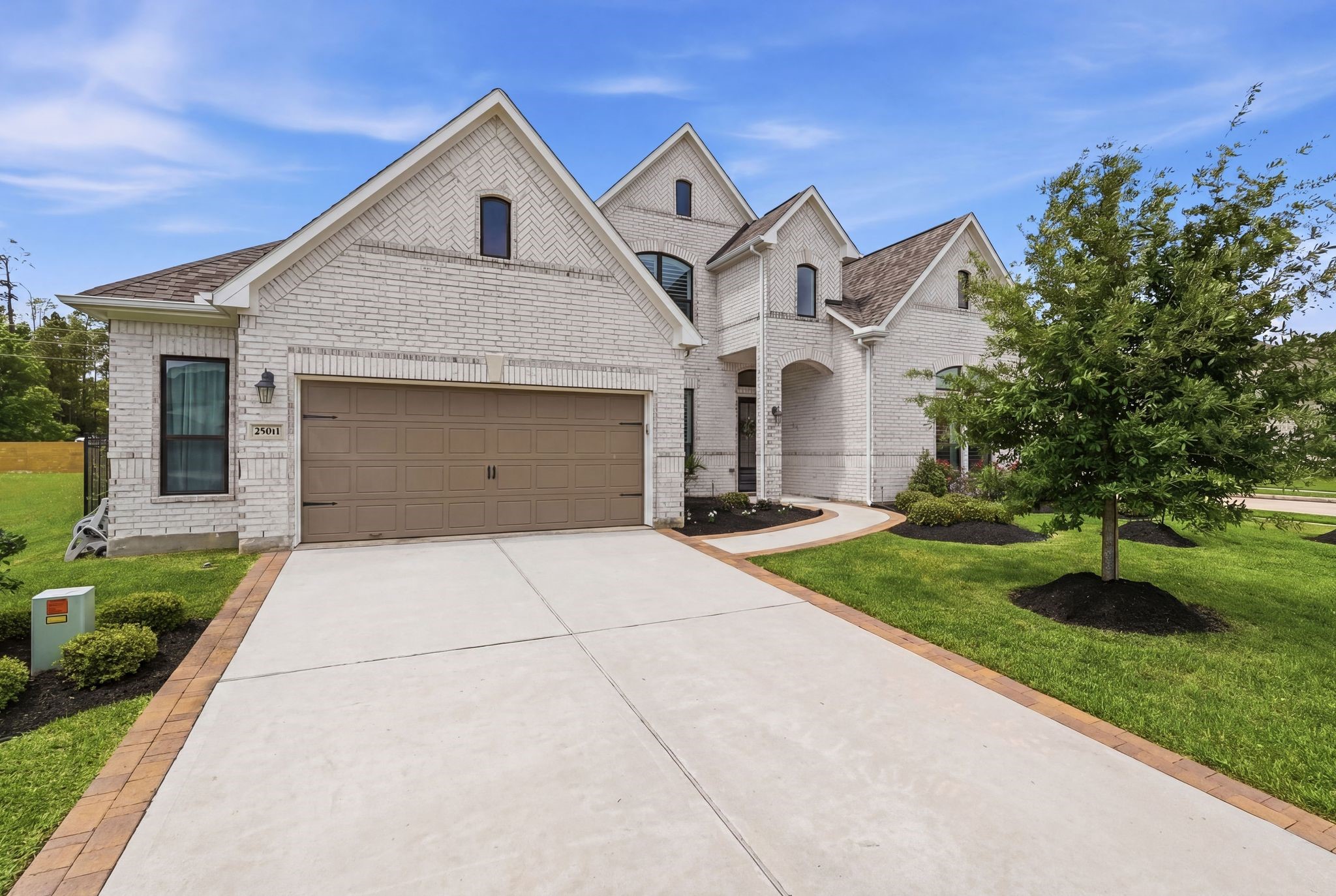 25011 Oxbow Lake Lane Spring, TX 77389 - Photo 2 of 33 a front view of a house with a yard and garage
