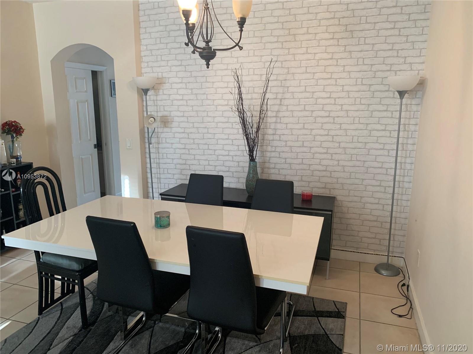 3915 Southwest 155th Avenue, Unit 313 Miramar, FL 33027 - Photo 2 of 10 a view of a dining room with furniture and chandelier