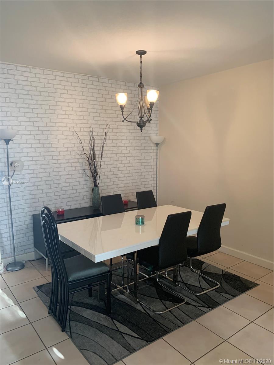 3915 Southwest 155th Avenue, Unit 313 Miramar, FL 33027 - Photo 3 of 10 a view of a dining room with furniture and wooden floor