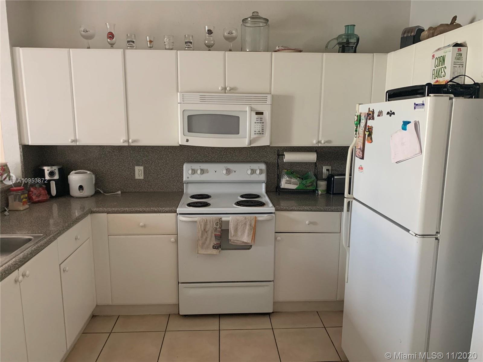 3915 Southwest 155th Avenue, Unit 313 Miramar, FL 33027 - Photo 4 of 10 a white refrigerator freezer sitting inside of a kitchen