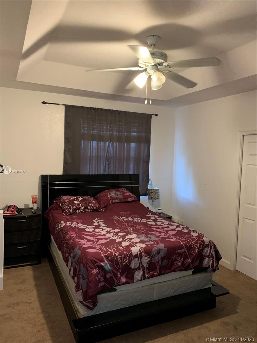 3915 Southwest 155th Avenue, Unit 313 Miramar, FL 33027 - Photo 6 of 10 a large bed sitting in a bedroom next to a lamp