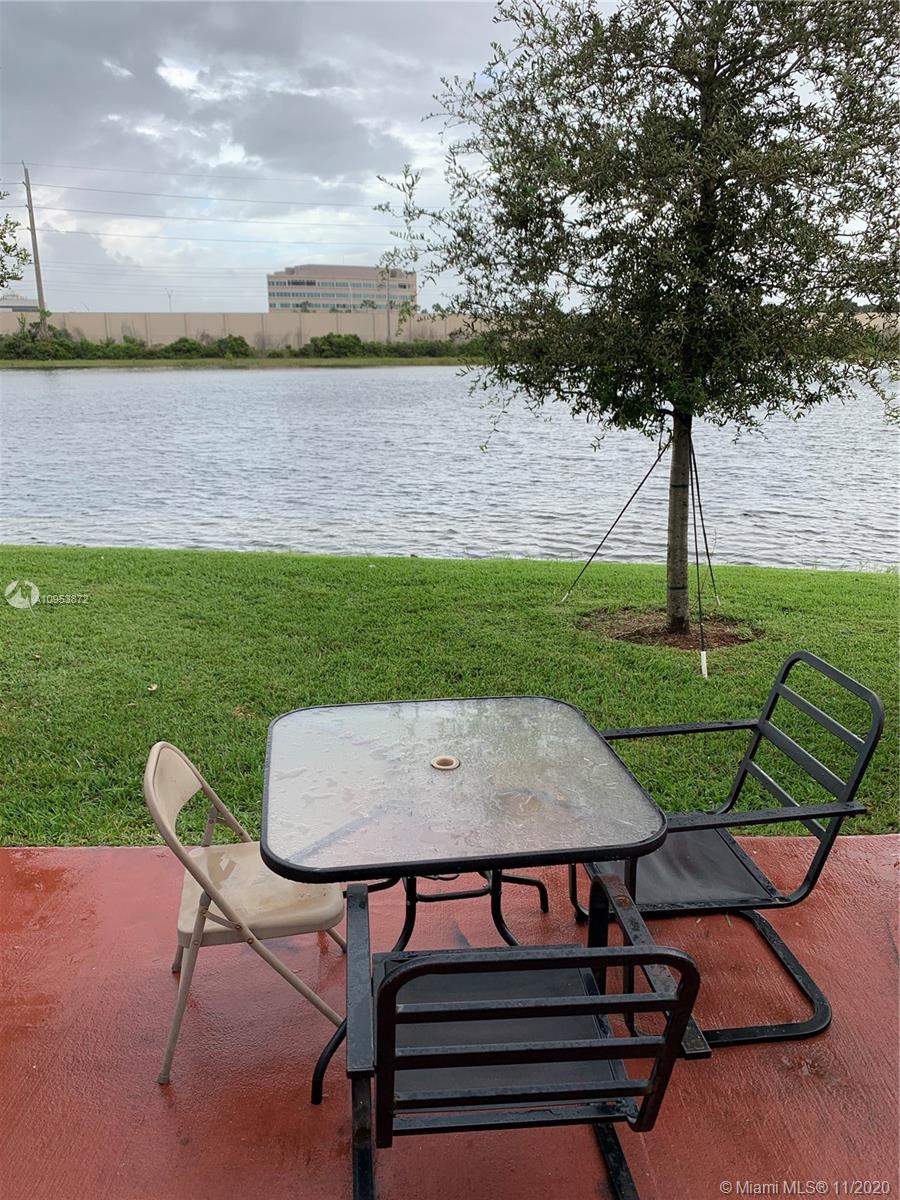 3915 Southwest 155th Avenue, Unit 313 Miramar, FL 33027 - Photo 9 of 10 a view of a chairs and table in the garden