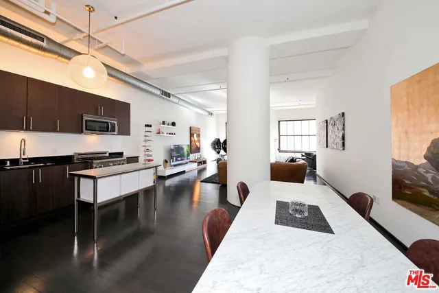 a kitchen with a sink appliances and cabinets