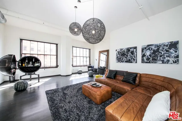 a bedroom with furniture and a flat screen tv