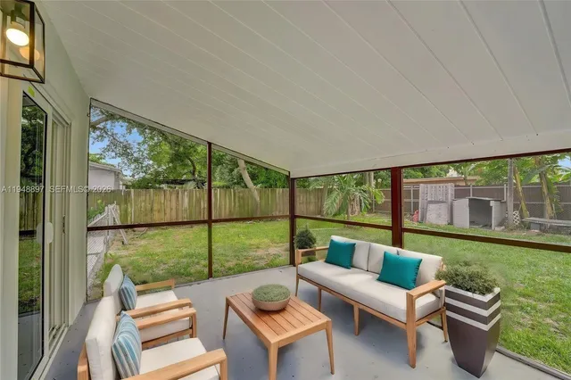 a balcony with furniture and a garden