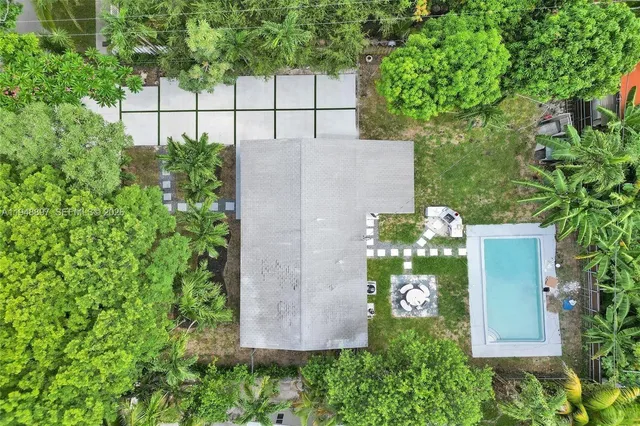 an aerial view of house with yard and seating space