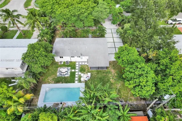 an aerial view of a house with a yard and garden