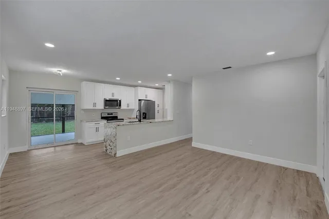 a kitchen with stainless steel appliances a refrigerator stove microwave and sink