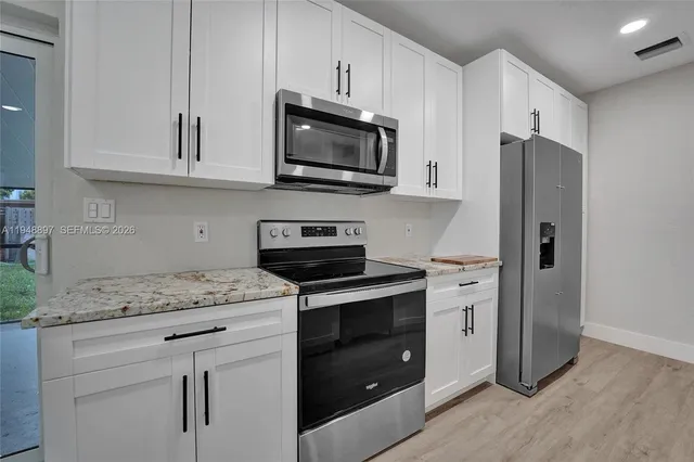 a kitchen with a sink and a stove