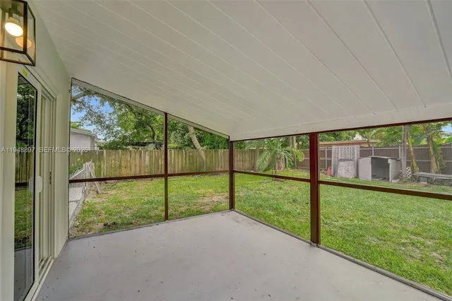 a white house with trees in front of it