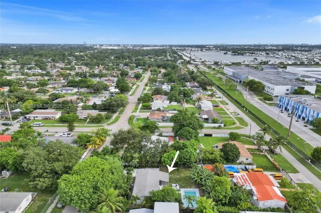 an aerial view of a houses with a yard