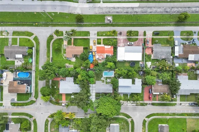an aerial view of a house with a yard