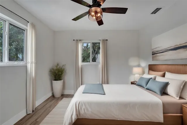 a bedroom with a large bed and a window