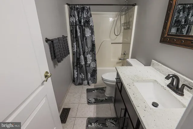 a bathroom with a sink and a shower curtain