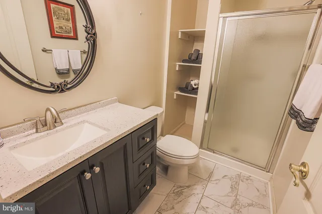 a bathroom with a sink a toilet and a mirror