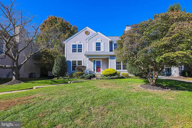a view of a house with backyard and a tree