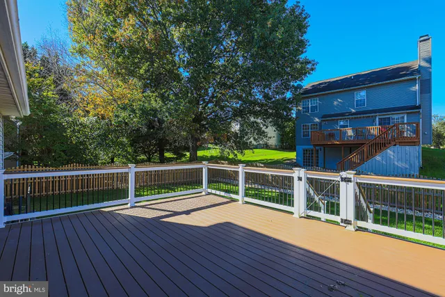 a view of house with backyard and a tree