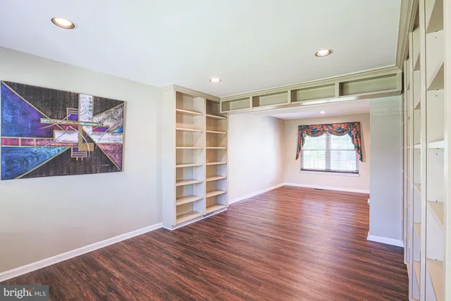 a view of a room with wooden floor and window
