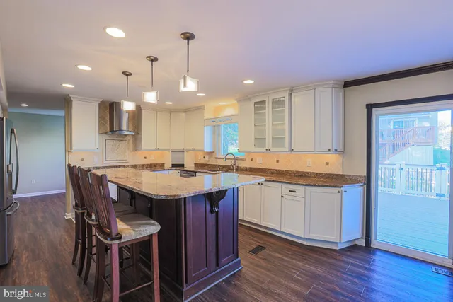 a kitchen with a sink cabinets and wooden floor