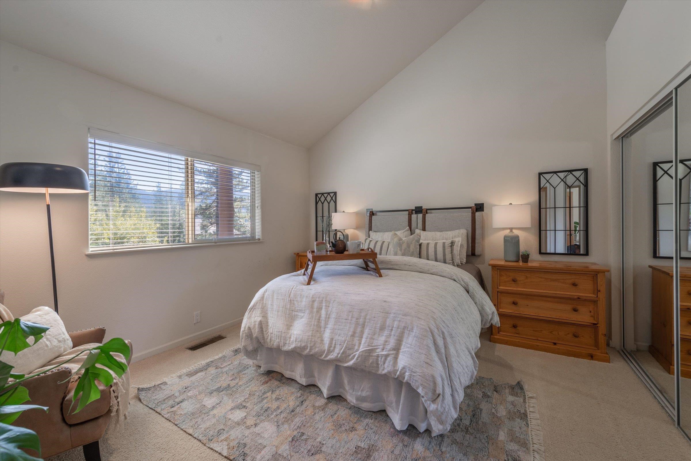 192 Hidden Lake Loop Olympic Valley, CA 96146 - Photo 17 of 21 a bedroom with a bed potted plant and two windows