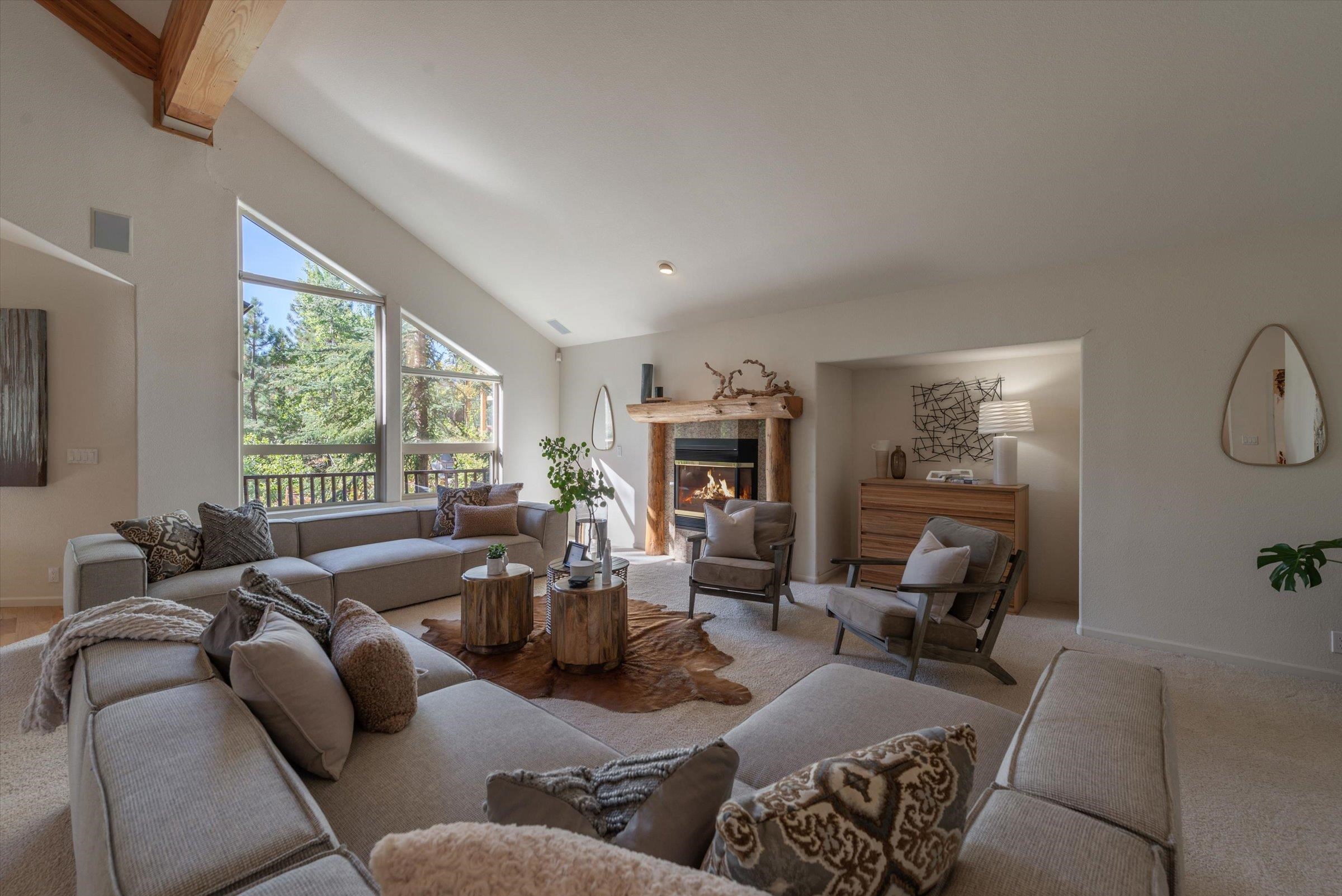 192 Hidden Lake Loop Olympic Valley, CA 96146 - Photo 6 of 21 a living room with furniture a large window and a fireplace