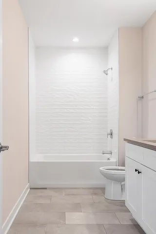 a bathroom with a toilet and a bathtub
