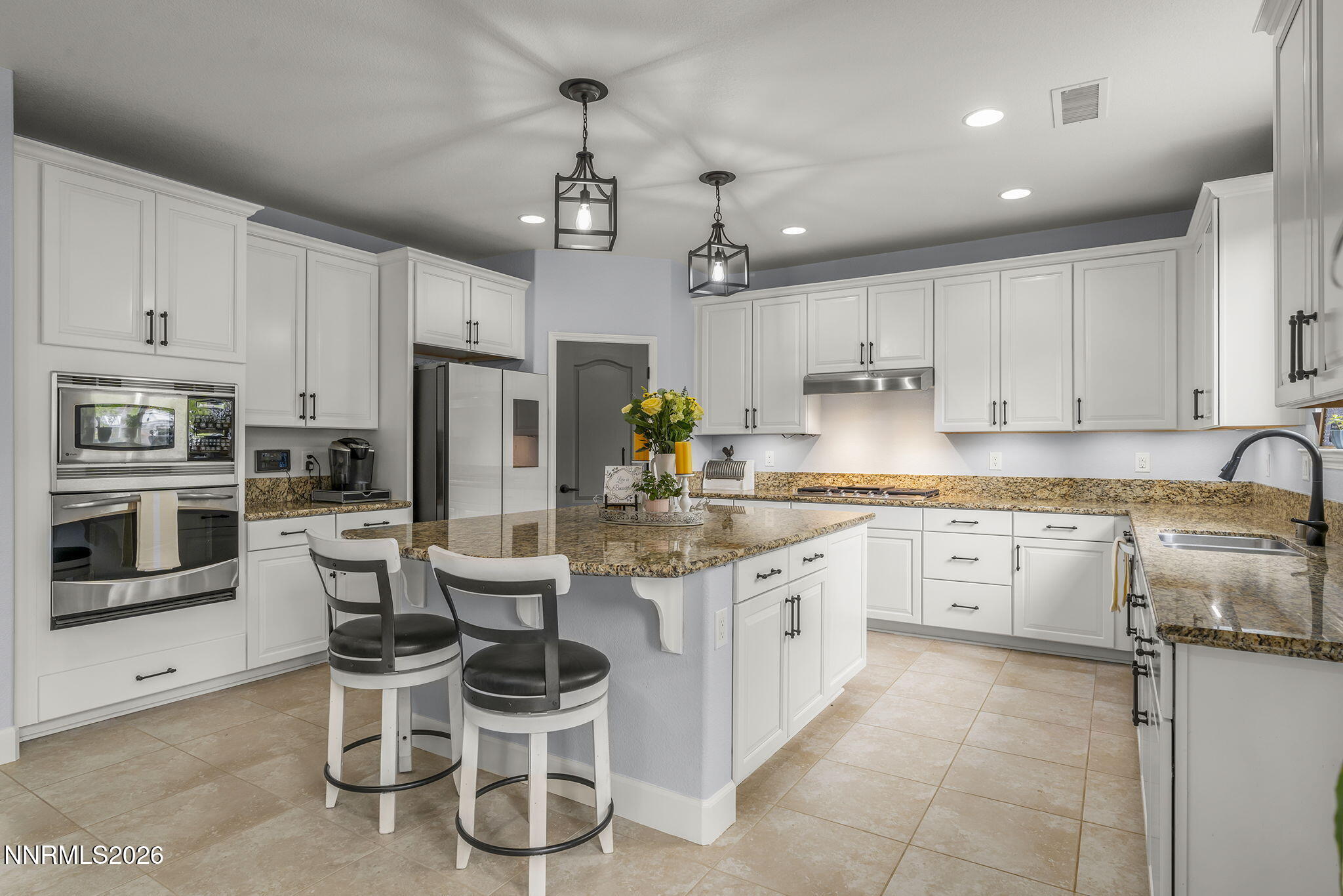 2960 Tobiano Drive Reno, NV 89521 - Photo 24 of 77 a kitchen with a sink counter top space stainless steel appliances and cabinets