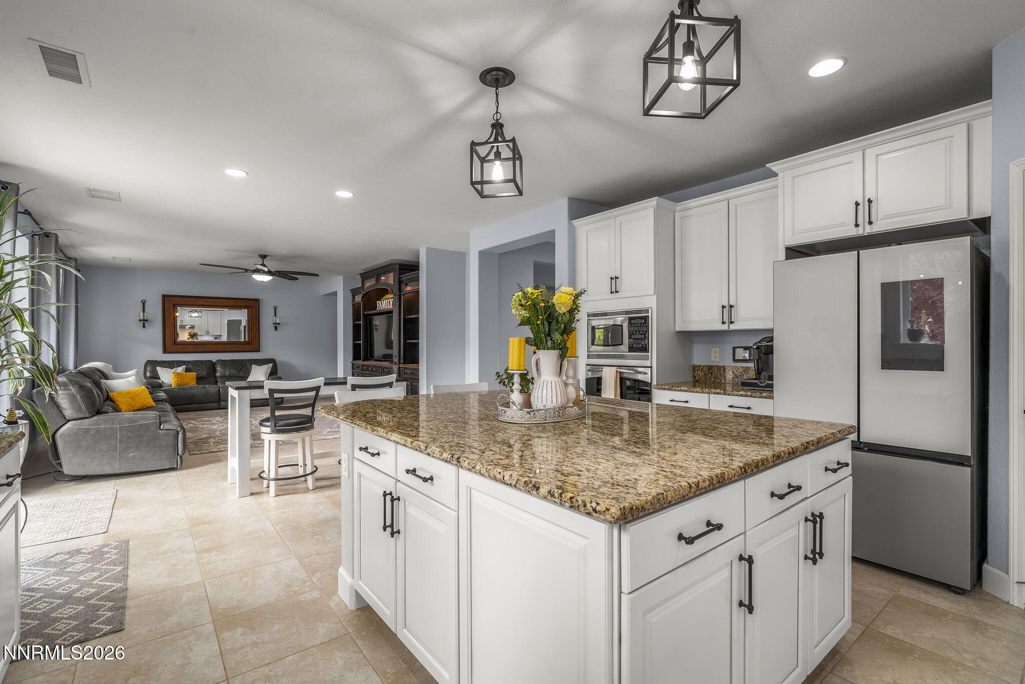 2960 Tobiano Drive Reno, NV 89521 - Photo 26 of 77 a kitchen with stainless steel appliances granite countertop a sink a stove a refrigerator cabinets and chairs