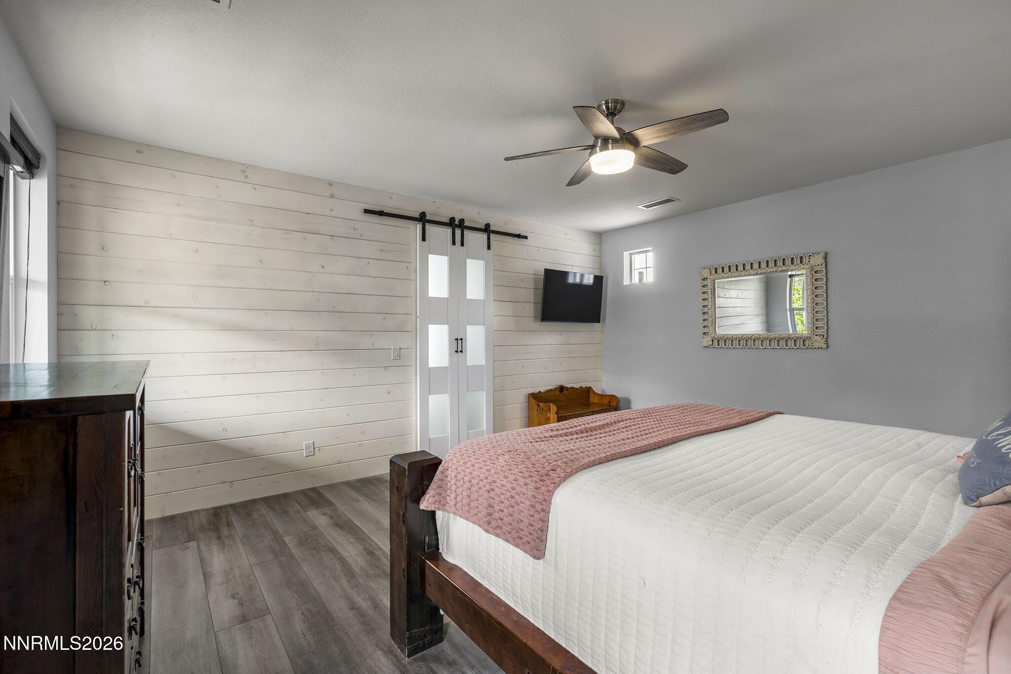 2960 Tobiano Drive Reno, NV 89521 - Photo 28 of 77 a bedroom with a bed and a chandelier