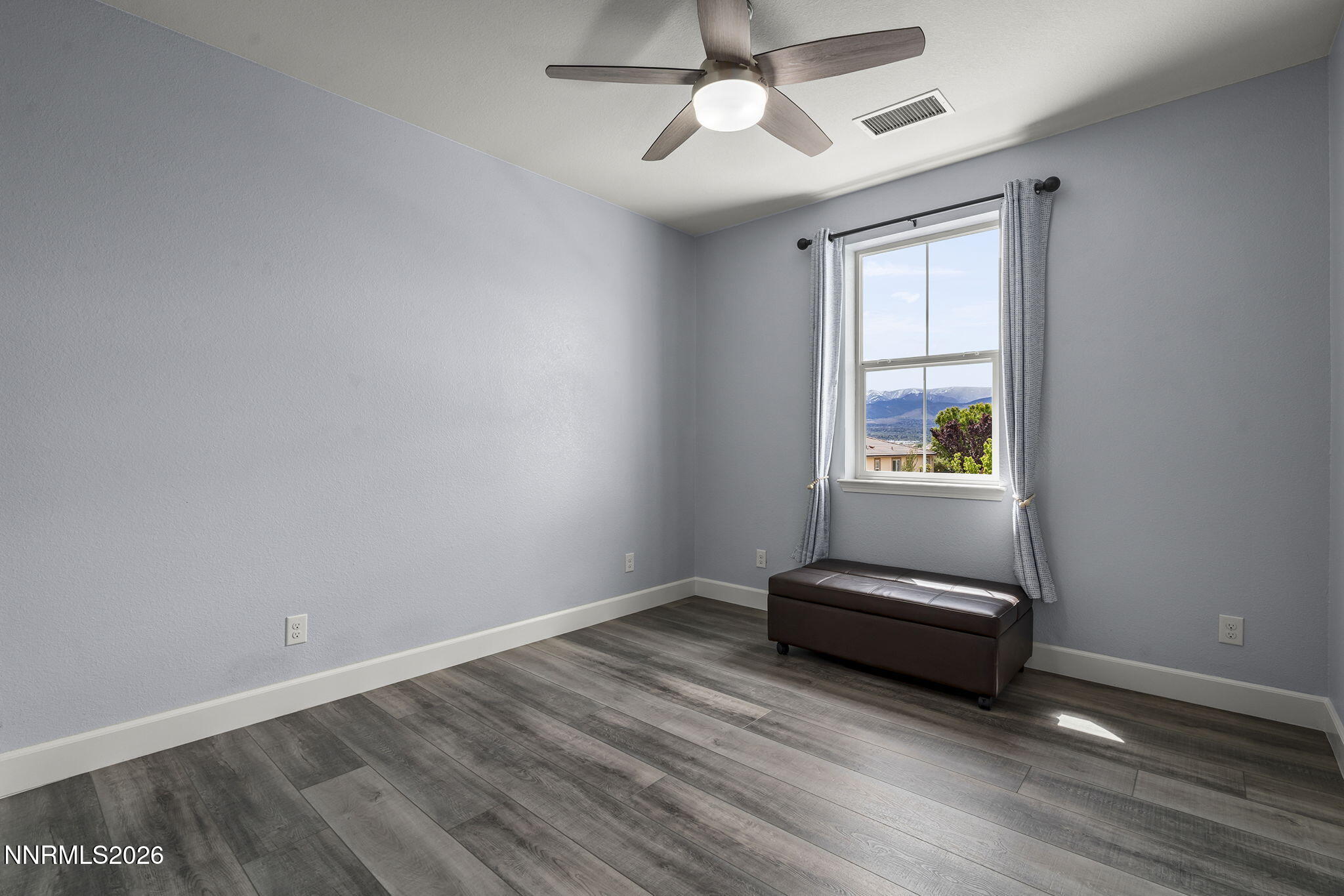 2960 Tobiano Drive Reno, NV 89521 - Photo 36 of 77 an empty room with windows and ceiling fan