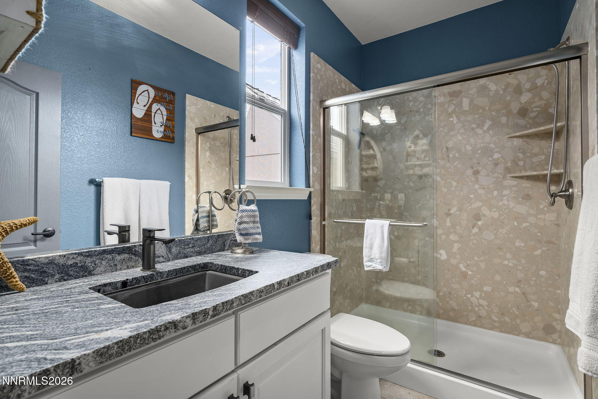 2960 Tobiano Drive Reno, NV 89521 - Photo 40 of 77 a bathroom with a granite countertop sink a toilet and shower
