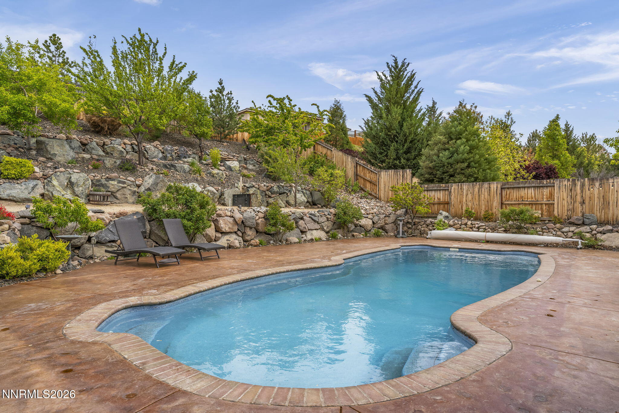 2960 Tobiano Drive Reno, NV 89521 - Photo 48 of 77 a view of a swimming pool with a yard