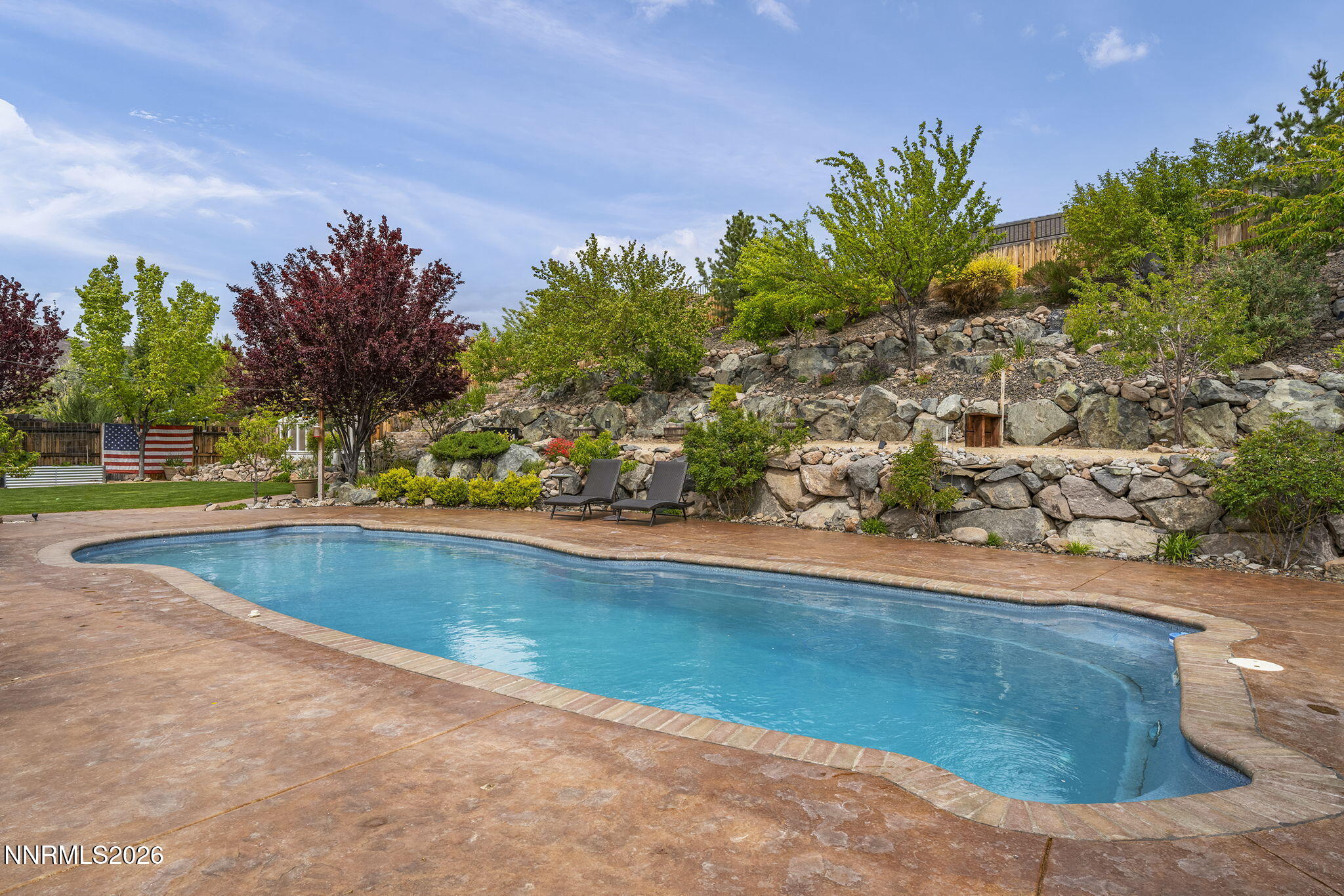 2960 Tobiano Drive Reno, NV 89521 - Photo 49 of 77 a view of a swimming pool with an outdoor space and seating area